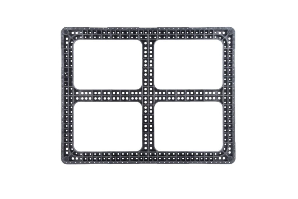 A plastic pallet with four holes on a white background.