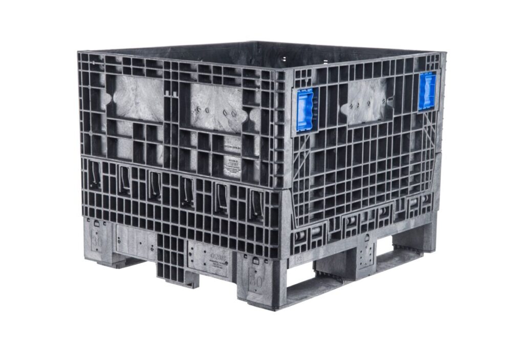 A gray pallet crate with blue handles, also known as a collapsible bulk container.