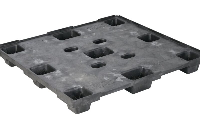 A black plastic pallet with holes.